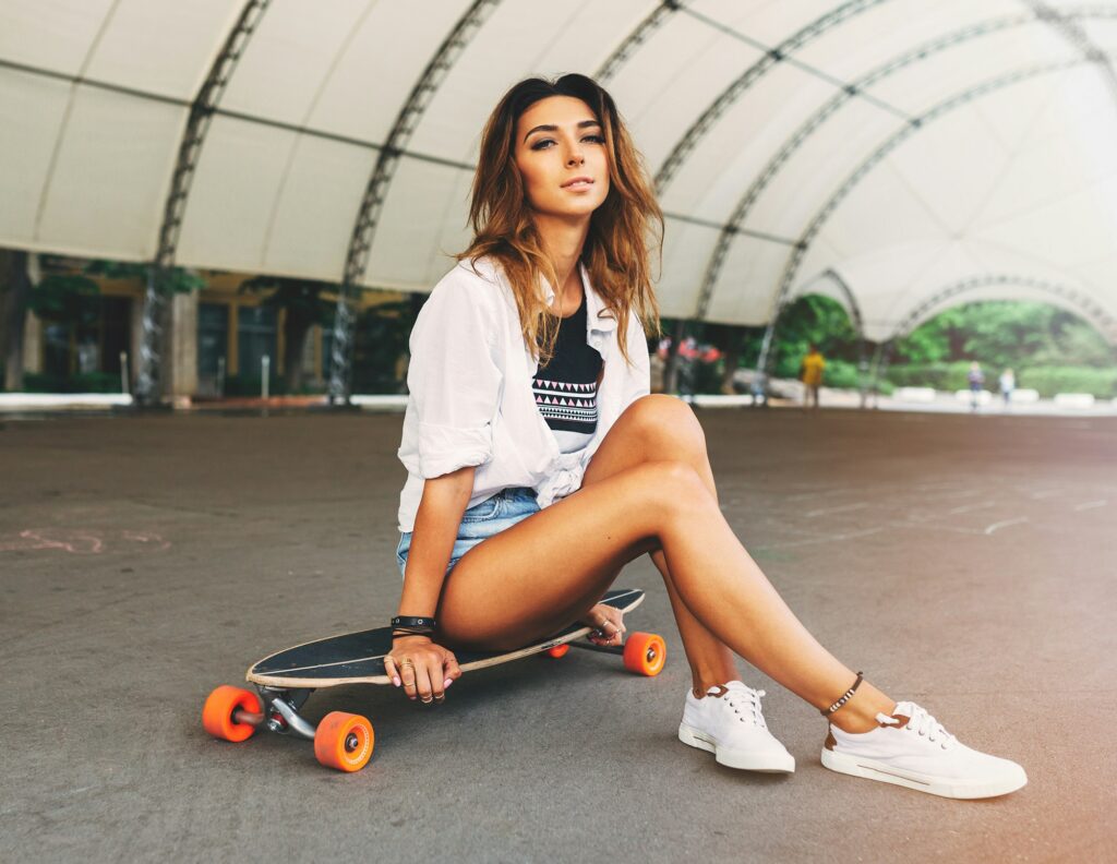 Fashion lifestyle, beautiful young woman with longboard. Lightle